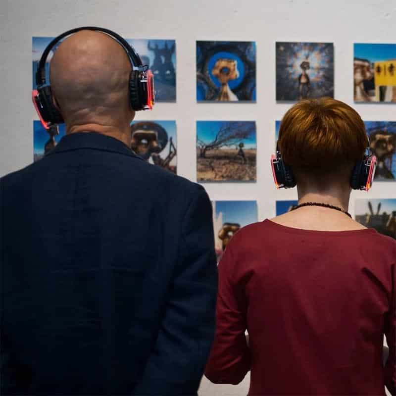 Silentart Photo Show Visitors wearing headphones at a photography exhibition