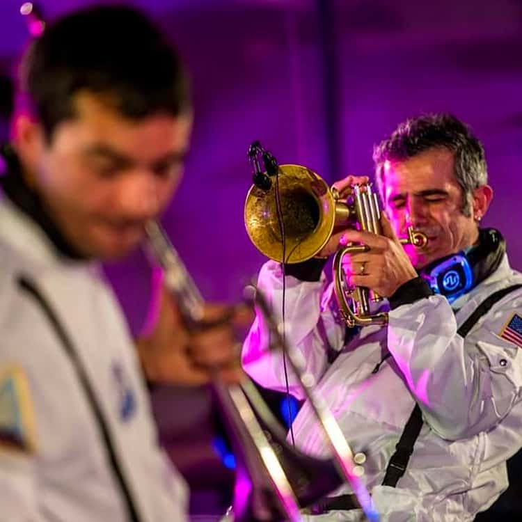 Concerti Silent $ Live Band Trombonists in astronaut suits playing with headphones