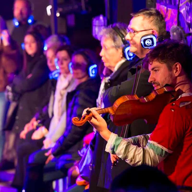silent-opera-vixen Violinist and audience with wireless headphones at a headphone opera