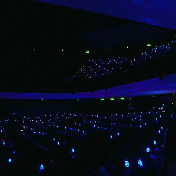 piccolo-teatro Darkened Piccolo Teatro audience with blue LED wireless headphones